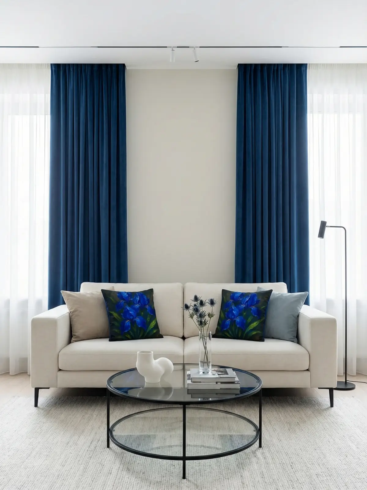 Contemporary gallery living room with blue velvet curtains, ivory sofa, and cobalt iris impasto pillows
