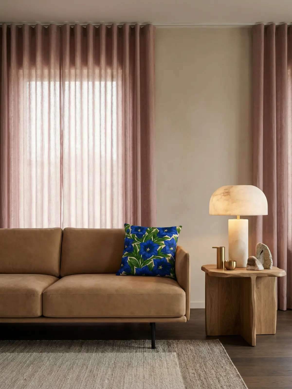Modern luxury living room with dusty rose curtains and Trumpet Gentian Botanical Pillow on a navy velvet sofa